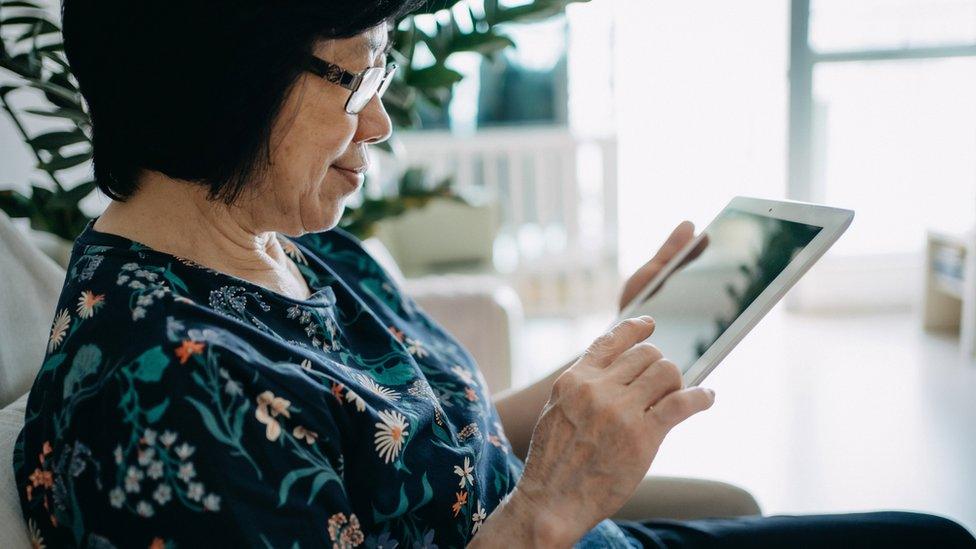 Woman reading off tablet