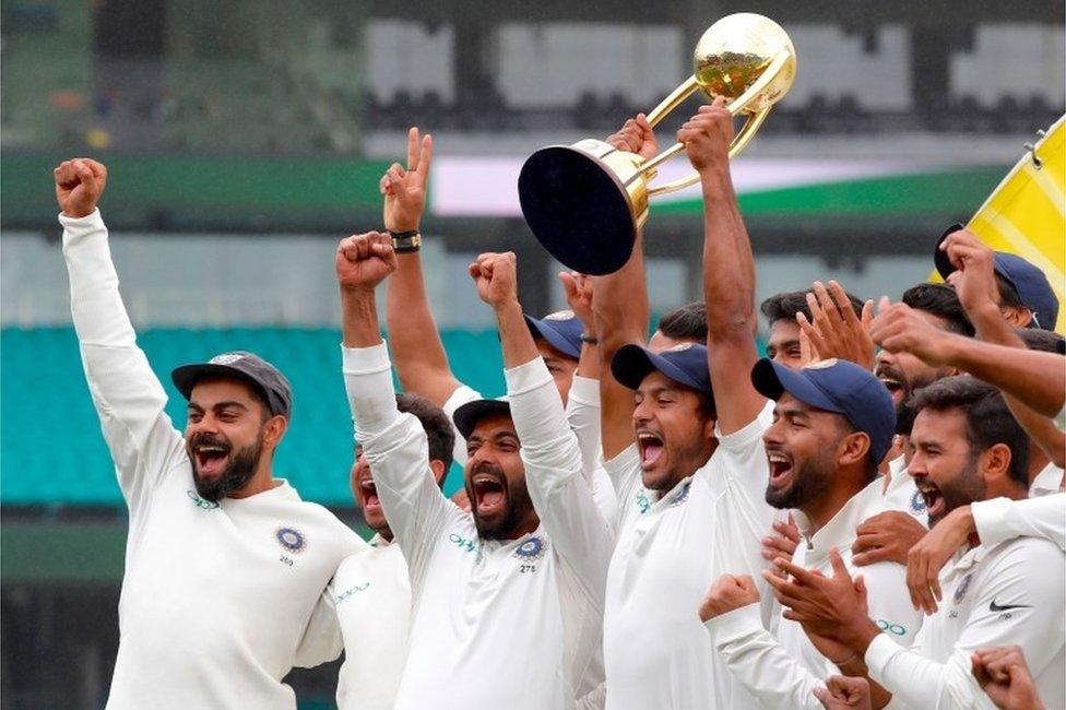 India"s captain Virat Kohli (L) celebrates with teammates as they pose with the Border-Gavaskar Trophy after winning the Test series between India and Australia at the Sydney Cricket Ground on January 7, 2019. (