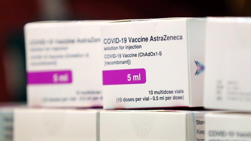 A vial of doses of the Oxford University/AstraZeneca Covid-19 vaccine is checked