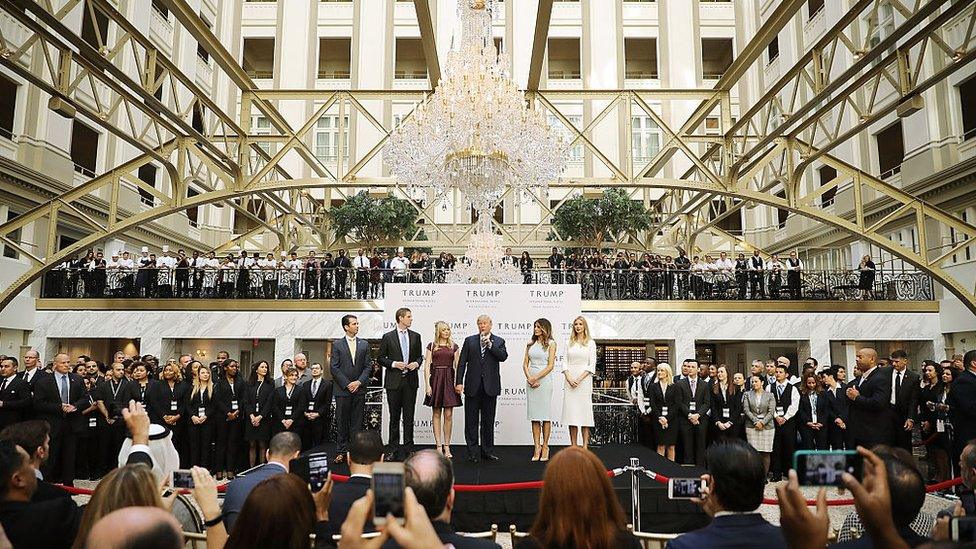 Republican presidential nominee Donald Trump (C) and his family (L-R) son Donald Trump Jr, son Eric Trump, wife Melania Trump and daughters Tiffany Trump and Ivanka Trump prepare to cut the ribbon at the new Trump International Hotel October 26, 2016 in Washington, DC