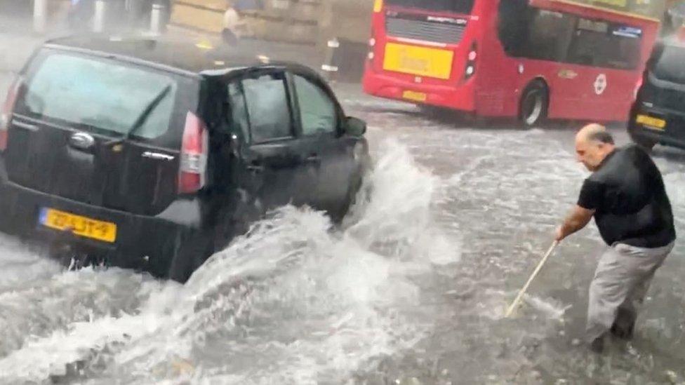 Man sweeping water