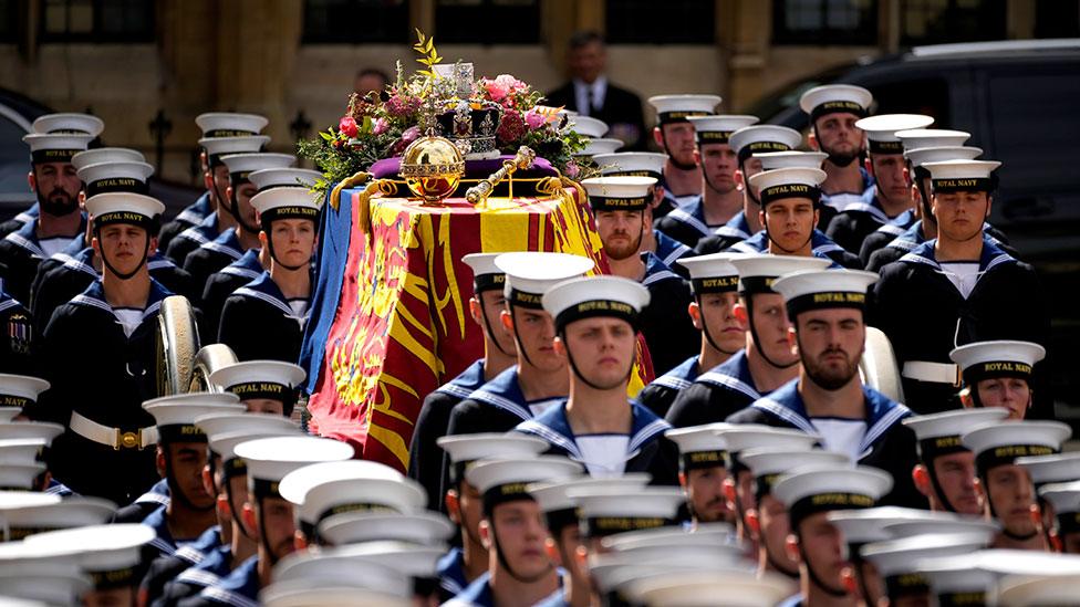 Coffin being carried on gun carriage