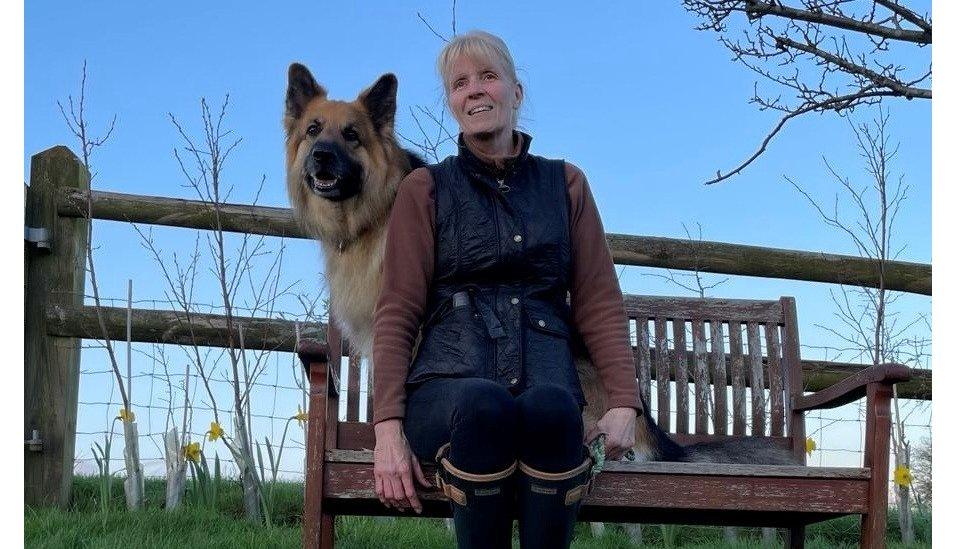 Jackie in a field with her dog