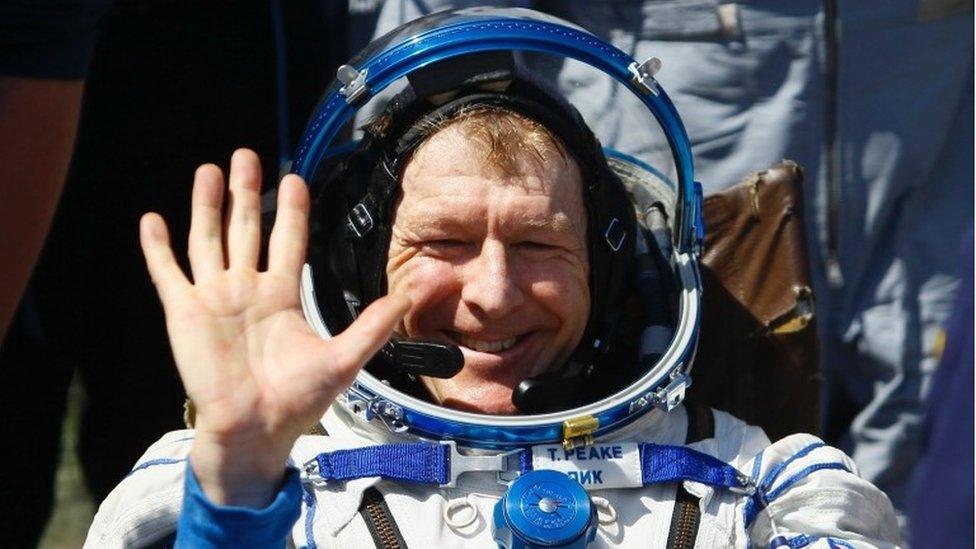 Tim Peake waves shortly after landing