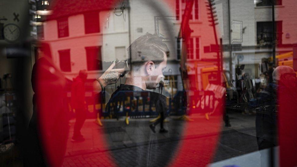 Man getting his hair cut in Saddler Street, Durham