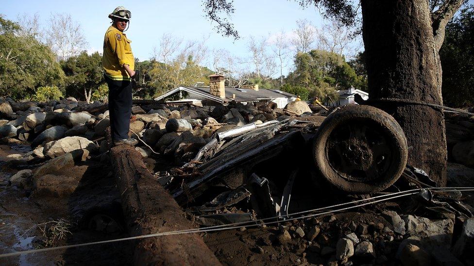 Rescue worker surveys debris after deadly mudslide in California. 10 Jan 2018