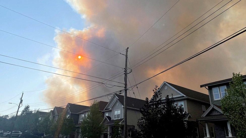 Smoke from the Tantallon wildfire rises over houses in nearby Bedford, Nova Scotia, Canada, May 28, 2023