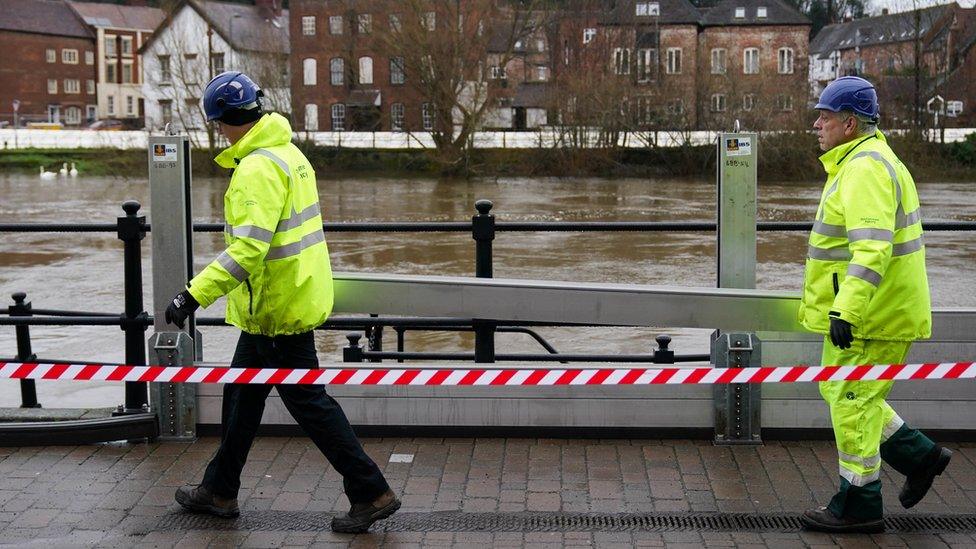 Workers from the Environment Agency install flood defences in Bewdley, Worcestershire, after heavy rain