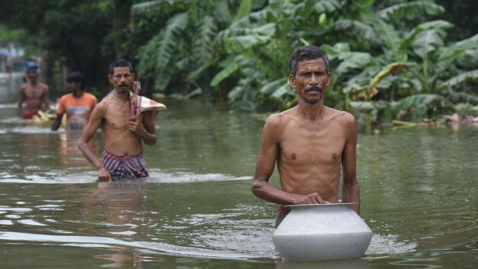 Villagers waded through flood water as the village is severely hit by the flood