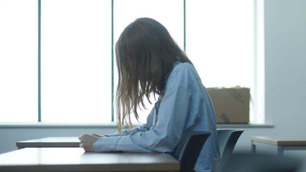 Girl sitting at school desk