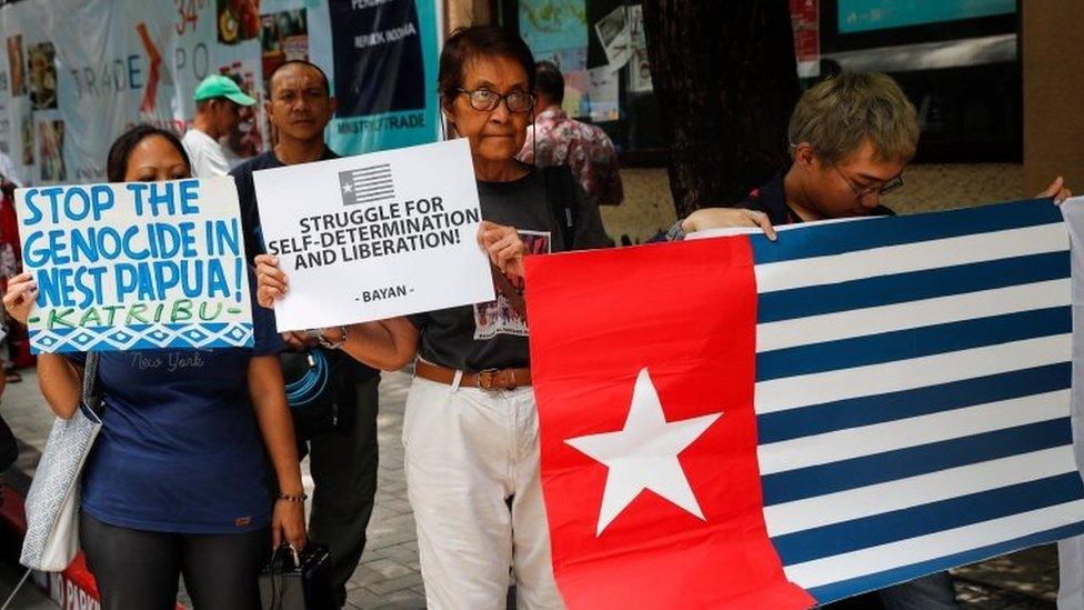 Activists hold banners and a West Papua flag (Morning Star flag) during a protest in front of the Indonesian Embassy in Manila