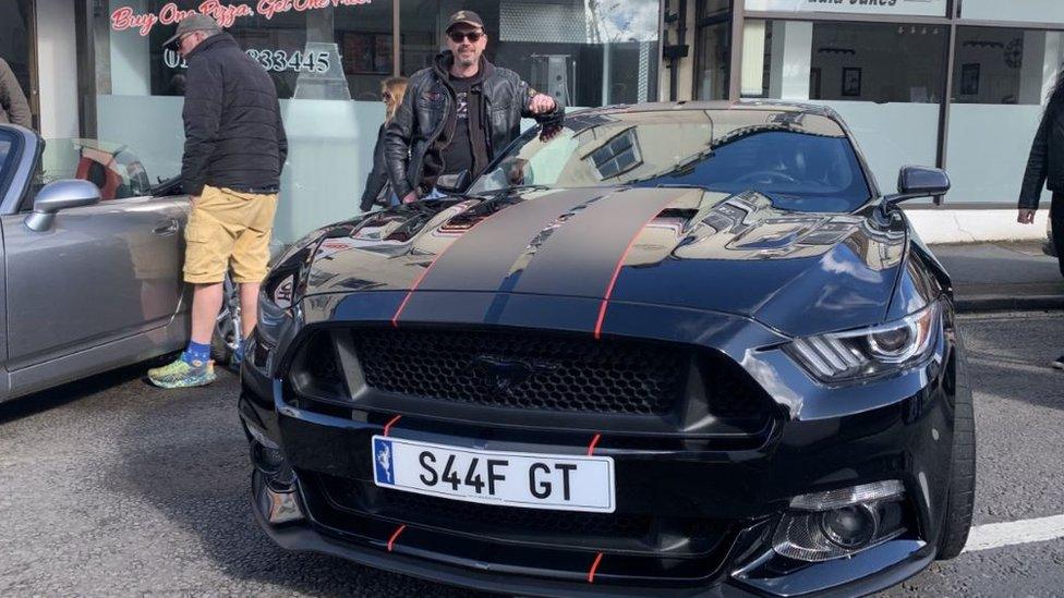 Jonathan Smith with his black Mustang