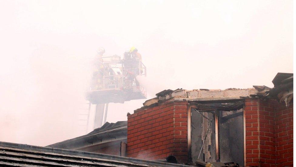 Badly fire-damaged roof at care home.