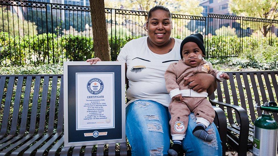 The baby and mother show their award