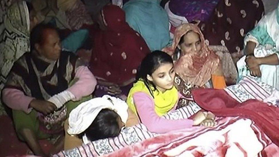 People mourn the death of their family member, in Toba Tek Singh, Pakistan, Monday, Dec. 26, 2016.