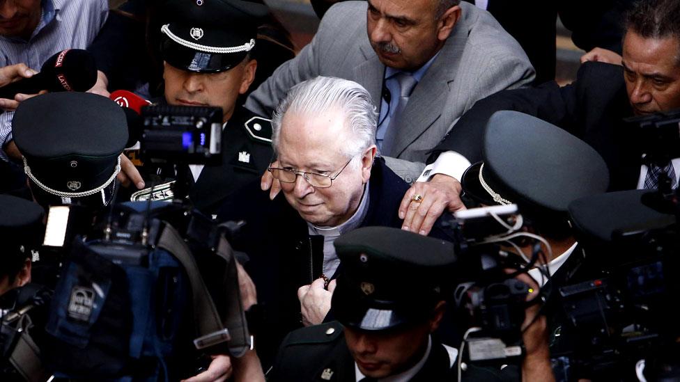 Chilean priest Fernando Karadima is surrounded by members of the media as he leaves the Supreme Court building in Santiago, Chile