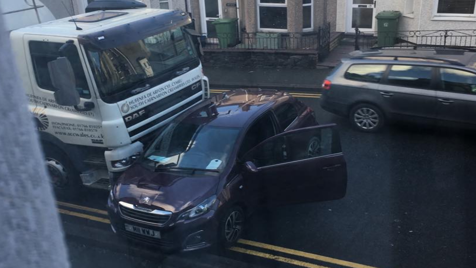 A truck colliding with a car on the A487