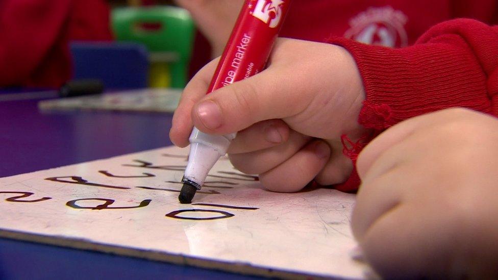 A child writes in a classroom