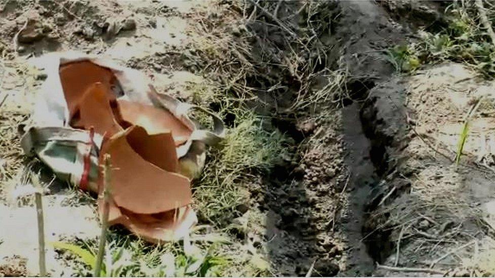 The broken pot in which the baby was buried