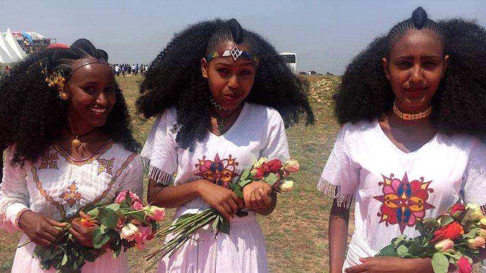 Young women holding flowers