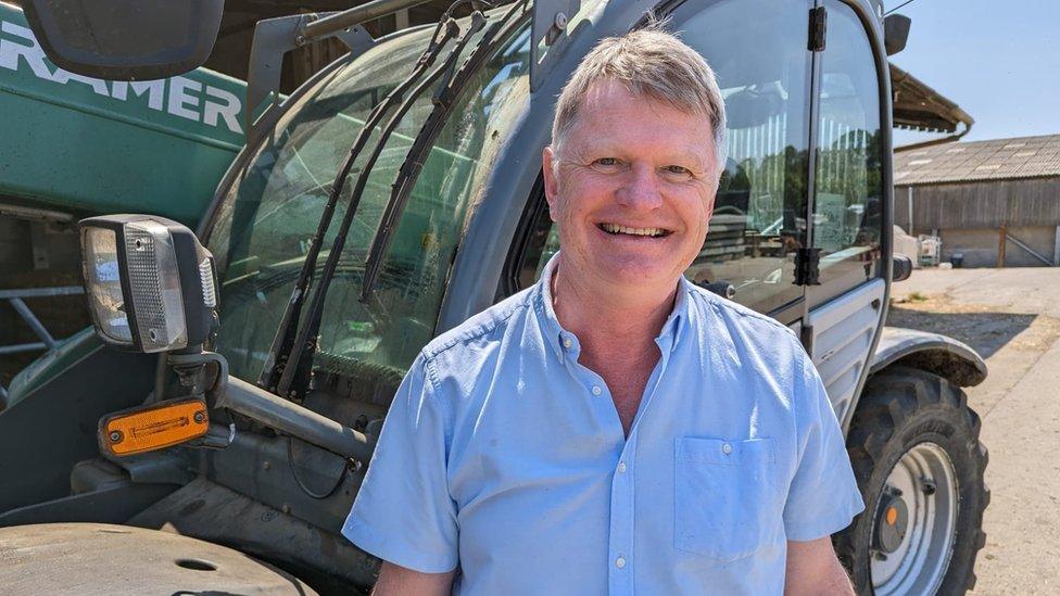 Mike Jones standing in front of a tractor