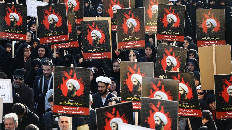 Iranians hold posters of Shia cleric Nimr al-Nimr at a protest in Tehran following his execution by Saudi Arabia (4 January 2016)