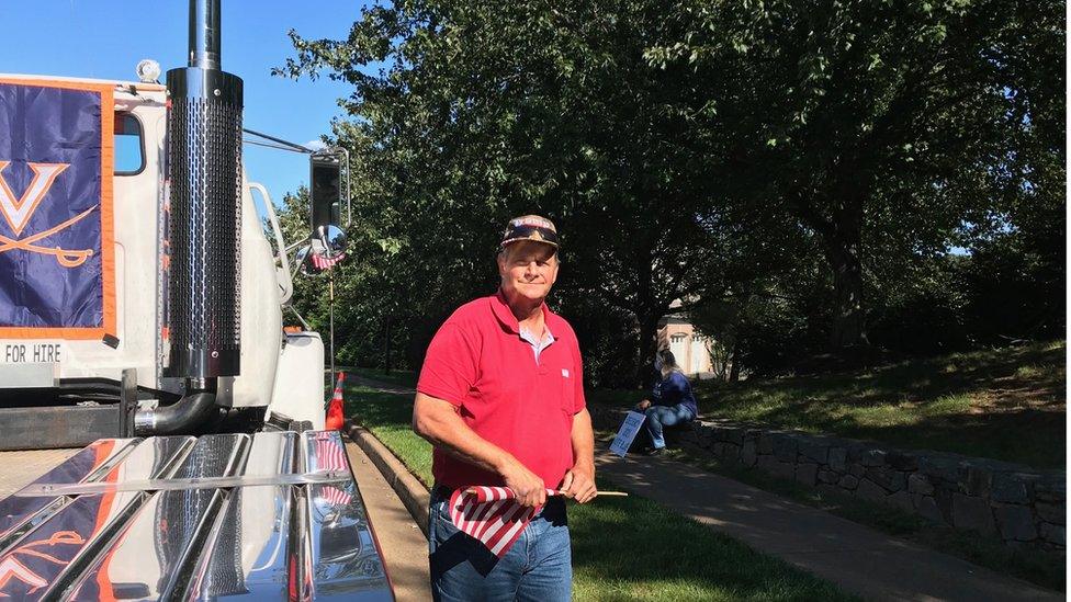 Roger Cole carries a US flag