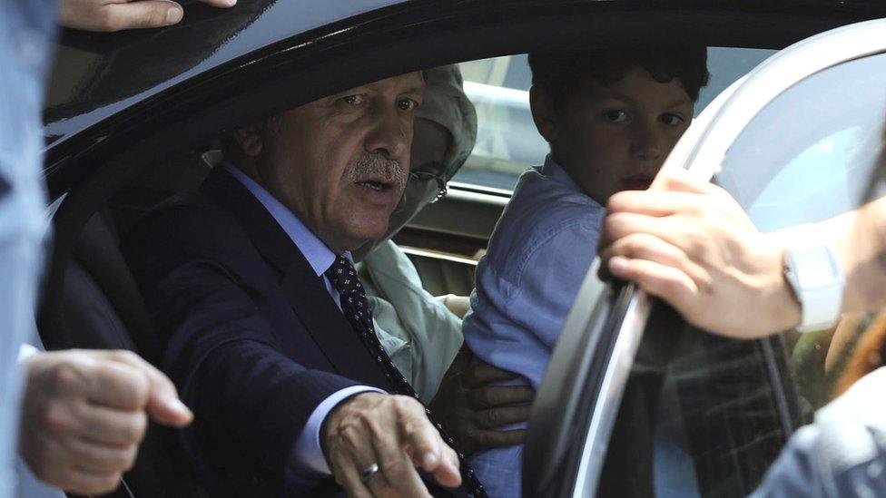 Turkish President Tayyip Erdogan sits inside a car with family members at Istanbul airport