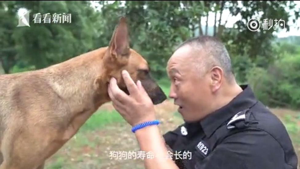 Police dog handler Bai Yan with Little Dragon, one of the retirement home residents