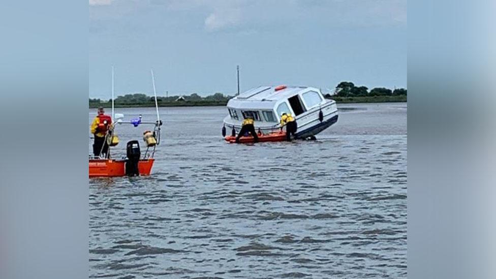 A cruiser being rescued by the Hemsby Lifeboat crew