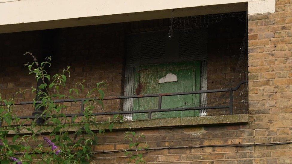 Boarded up window as part of the empty block of flats on Wellington Mews