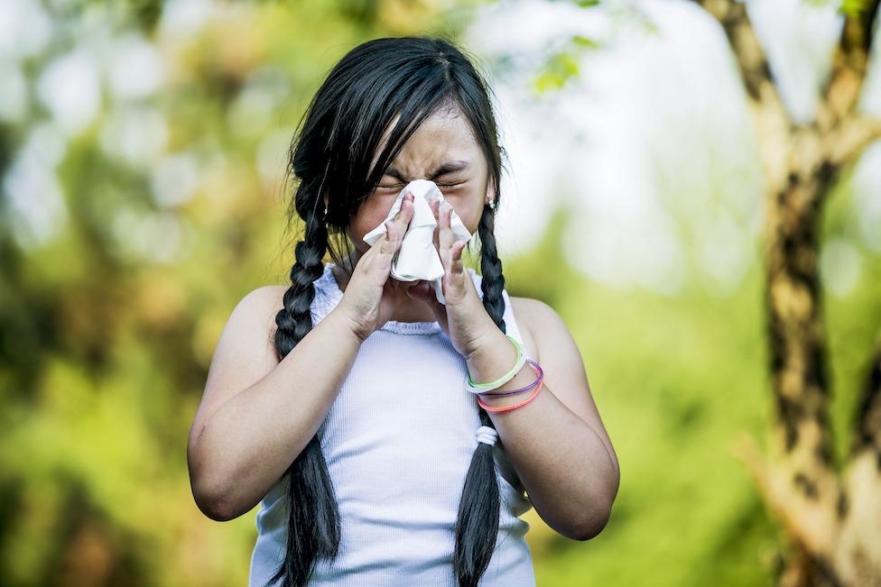 Girl blowing nose