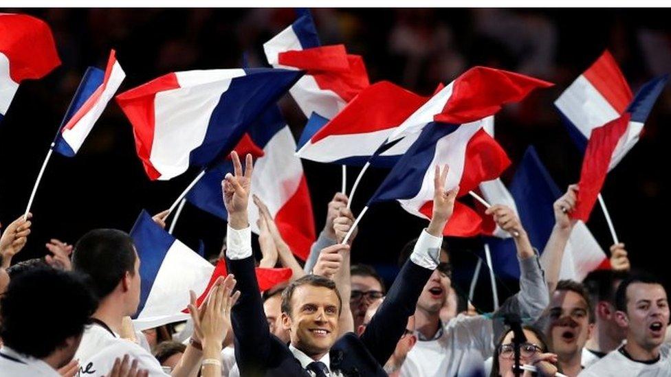 Emmanuel Macron (centre) campaigns in Paris. Photo: 17 April 2017