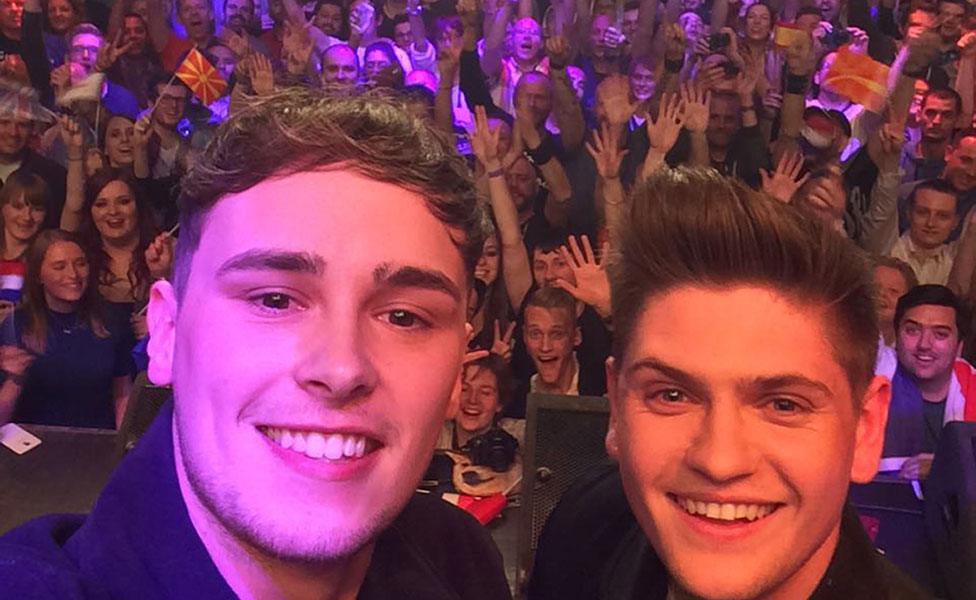 Joe and Jake, take a selfie on stage in Amsterdam