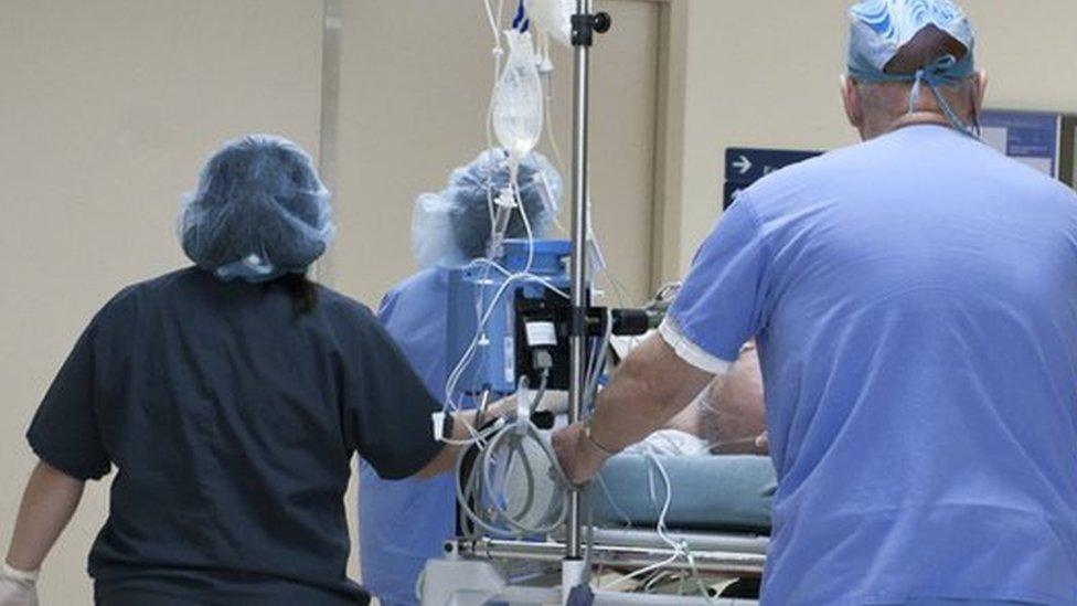 Hospital staff with a patient on a trolley