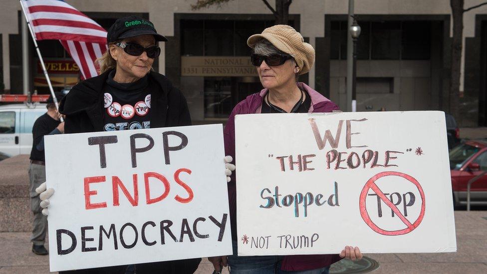 Protestors with anti-TPP signs