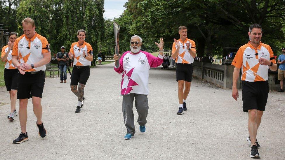 Batonbearer Joniah Parthasarathi holds the Queen's Baton