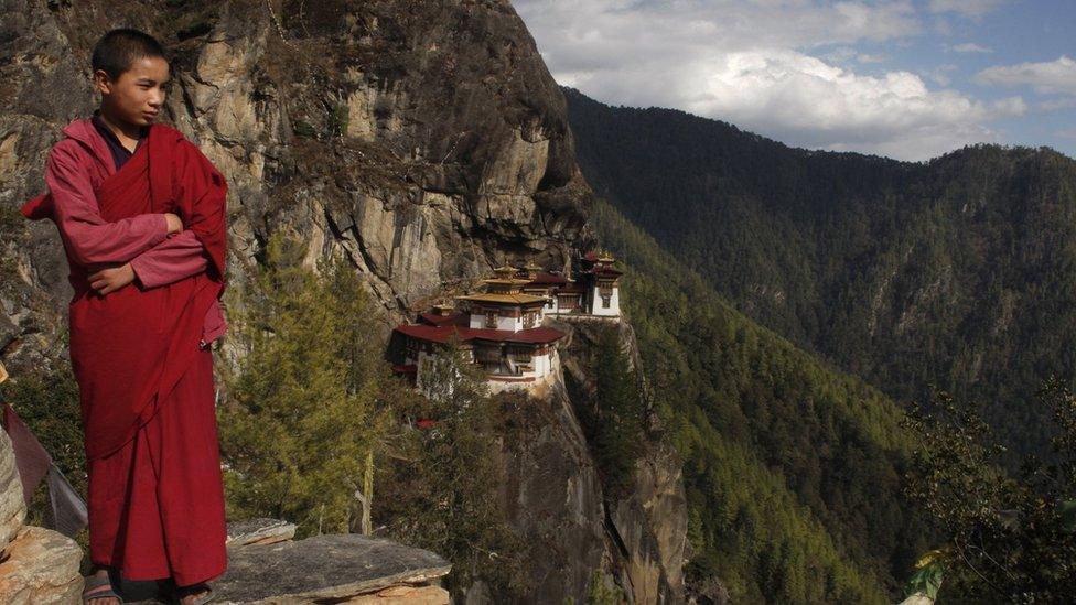 A boy monk on a mountainside