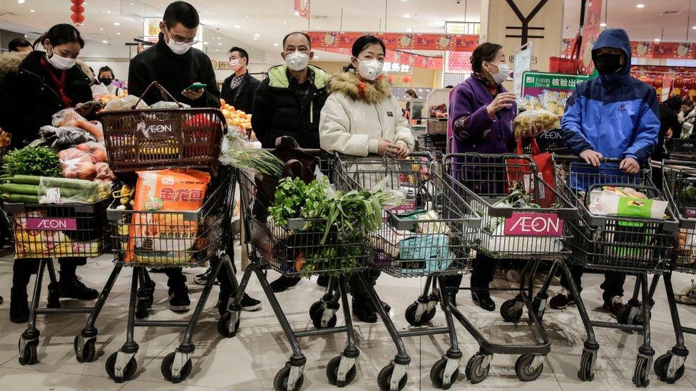 Wuhan residents buy food at a market