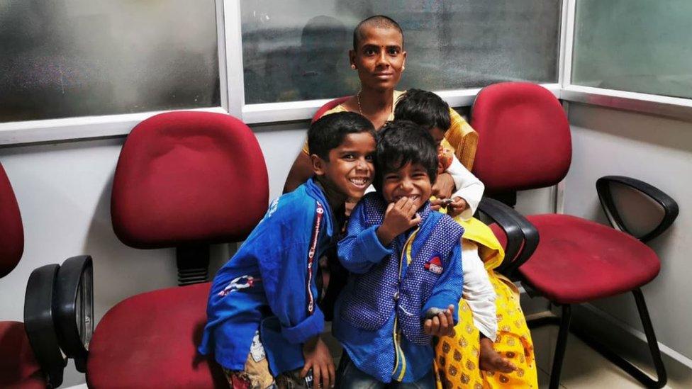 Prema with her kids waiting to meet a government official