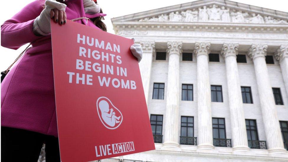 A pro-life activist holds a sign outside the US Supreme Court during the 48th annual March for Life January 29, 2021