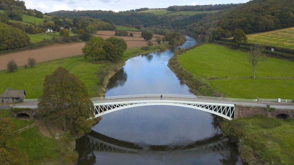 An aerial view of a pedestrian bridge over the River Wye in Llandogo