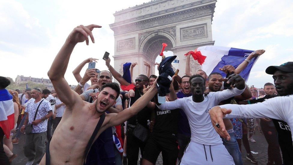 France fans react on the Champs-Elysees avenue after they defeated Croatia during their Soccer World Cup final match