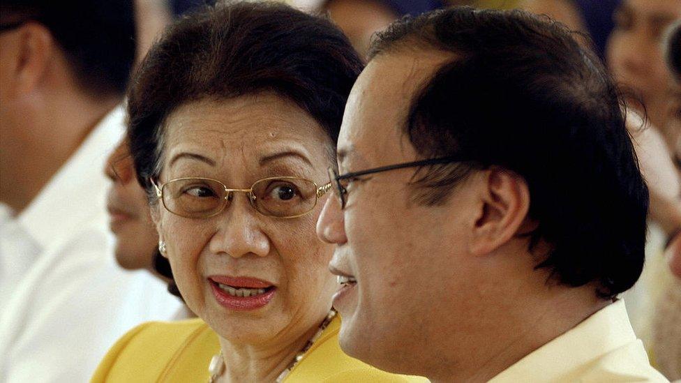 Former Philippine president Corazon Aquino (L), talks with her son Senator Noynoy during a memorial service at Manila Memorial Park in suburban Manila, 21 August 2007, marking the 24th anniversary of assassination of former opposition leader senator Benigno Aquino .