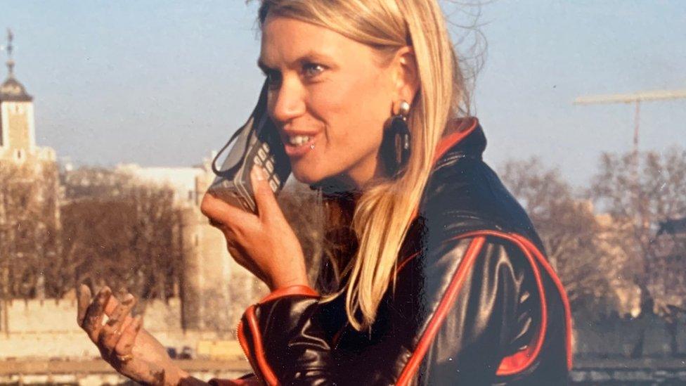 Anneka Rice with mobile phone and hard hat