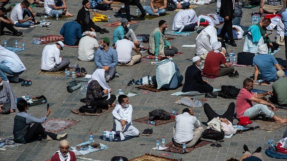 People gather before the first official Friday prayers outside Hagia Sophia Mosque on July 24, 2020 in Istanbul, Turkey