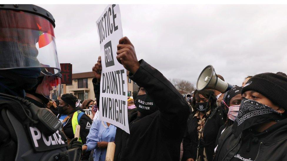 Protesters rally outside Brooklyn Center Police Department a day after Daunte Wright was shot and killed by a police officer, in Brooklyn Center, Minnesota