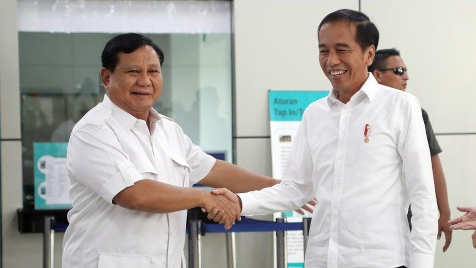 Widodo and Prabowo shake hands