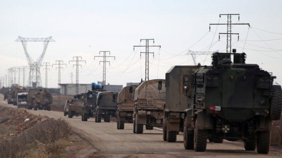 Turkish military vehicles drive in the Syrian rebel-held town of al-Rai, as they head towards the northern Syrian town of al-Bab, Syria, 9 January