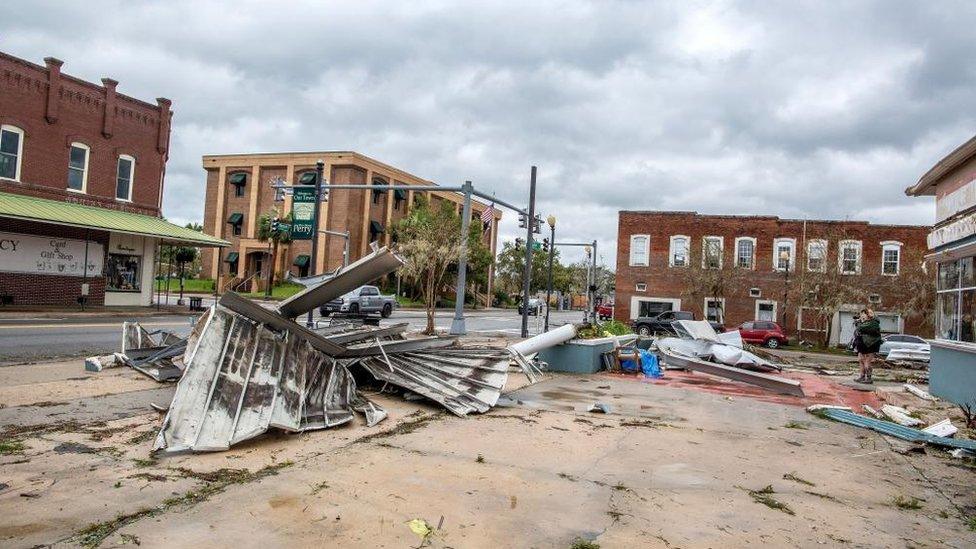 A person walks next to debris in the town of Perry, after Hurricane Idalia made landfall near Keaton Beach, Florida, USA, 30 August 2023. Hurricane Idalia makes landfall in Florida as a Category 3 storm with winds of 125 mph.